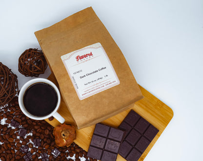 Kraft paper coffee bag with a label, cup of coffee, chocolate bars, and coffee beans on a white background