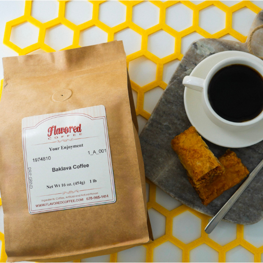 Flavored Coffee package with a cup of coffee and baklava on a yellow honeycomb patterned surface