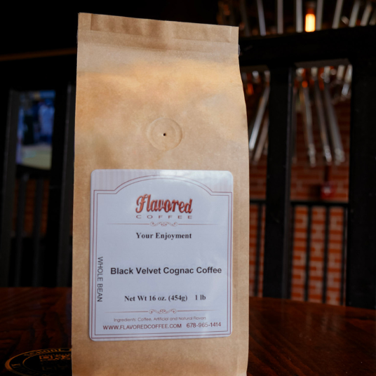 Bag of Flavored Coffee with a label on a wooden surface
