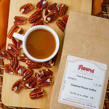 Cup of coffee with pecans on a wooden board next to a Flavored Coffee Company package.