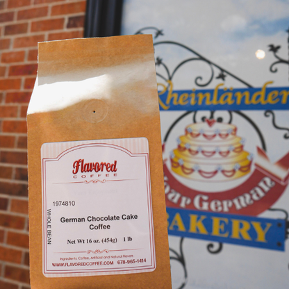 Bag of Flavored Coffee with German Chocolate Cake flavor in front of a bakery sign.