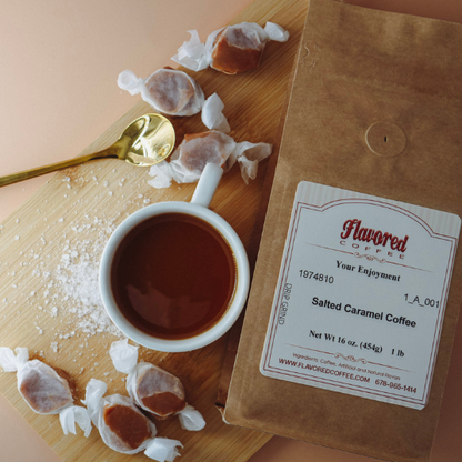 Bag of Flavored Coffee with a cup of coffee and salted caramel candies on a wooden board.