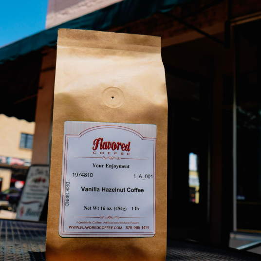 Brown paper bag of vanilla hazelnut coffee with a visible label in an outdoor setting.