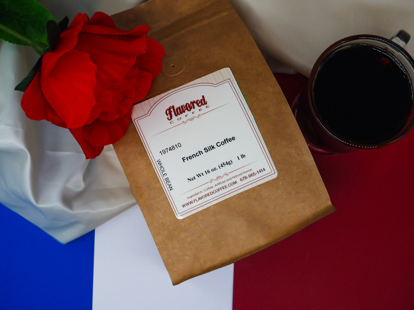 Kraft paper coffee bag with a label, red rose, and coffee cup on a white and red background